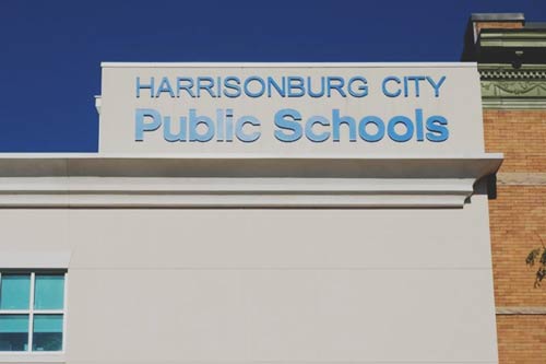 The sign on the top of the building of the Harrisonburg City Schools building in Harrisonburg, VA.