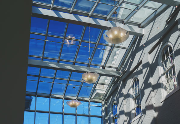 Looking up at the blue sky through atrium windows in Harrisonburg City Hall